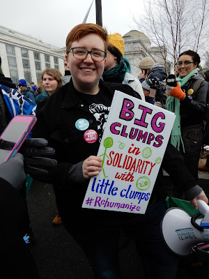 Herb holds a sign: "Big clumps in solidarity with little clumps"
