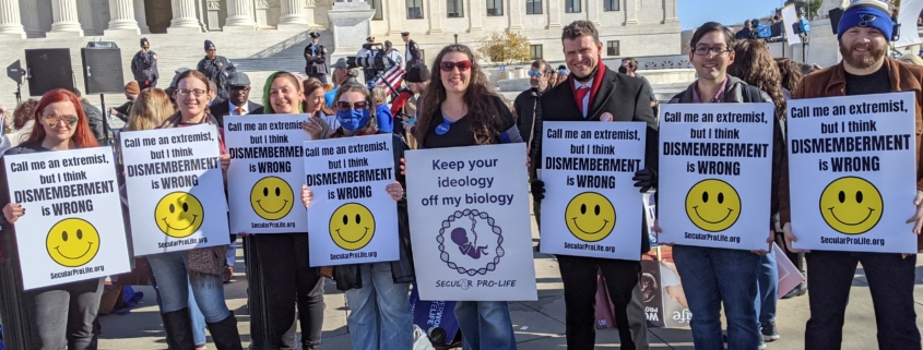 SPL supporters holding signs at the Dobbs rally outside the Supreme Court