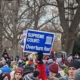 A sign reading "Supreme Court: Overturn Roe" above the March for Life crowd
