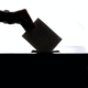 Silhouette of a person casting a ballot