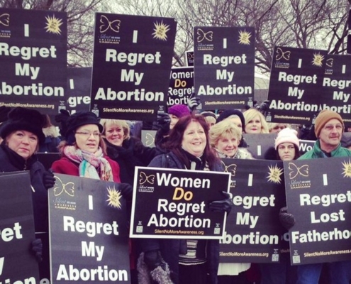 Crowd with "I Regret My Abortion" signs