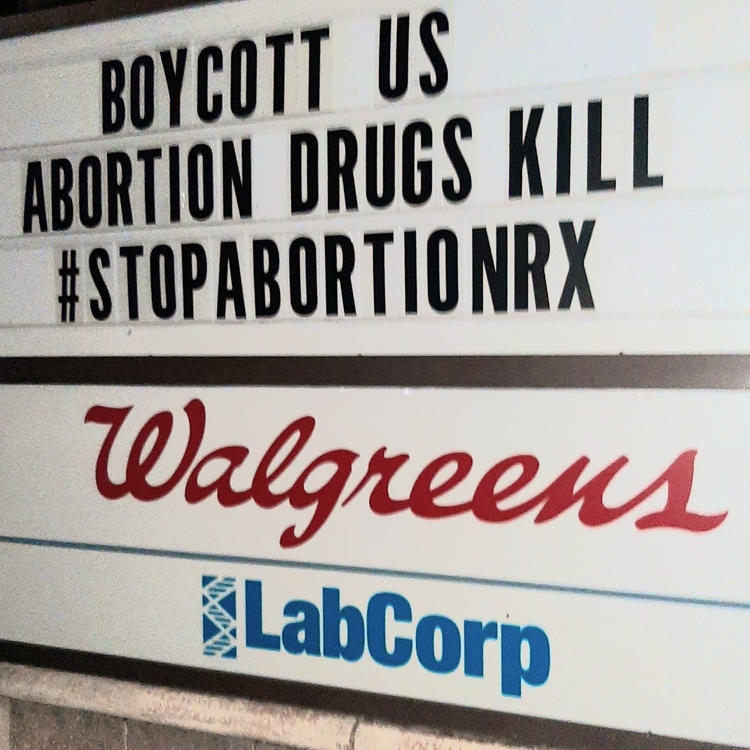 Walgreens sign that reads "Boycott us, abortion drugs kill, #stopabortionrx"