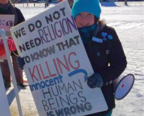 Woman with sign: we do not need religion